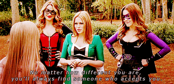 Haley, dressed as a superhero with Quinn and Brooke, tells a teenager