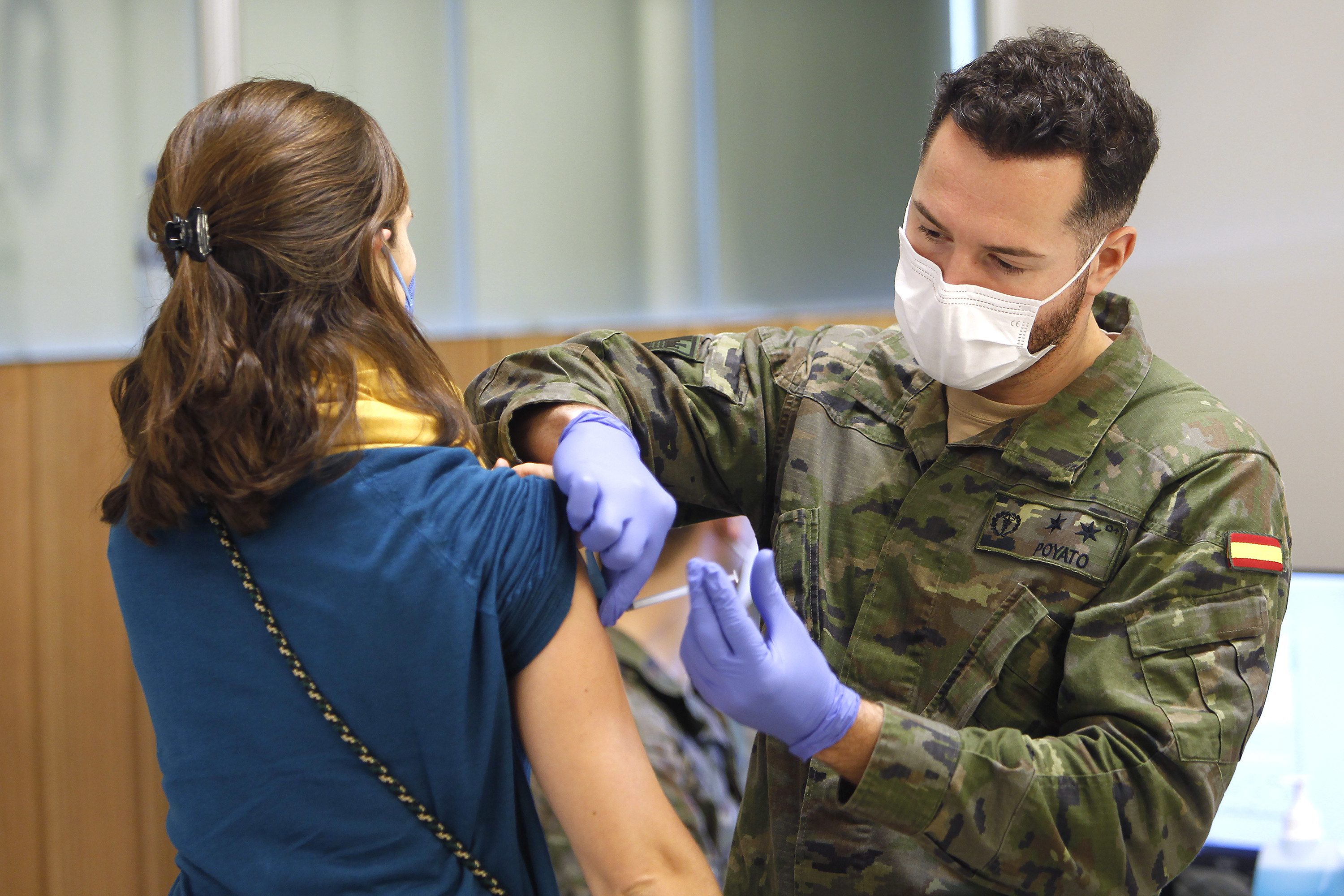 A woman gets a COVID vaccine