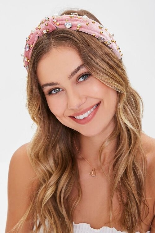 Model wearing pink velvet encrusted headband