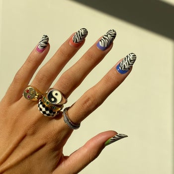 model wearing zebra print with colorful cuticle crescent nail stickers