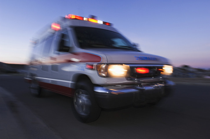 An ambulance speeds down a street