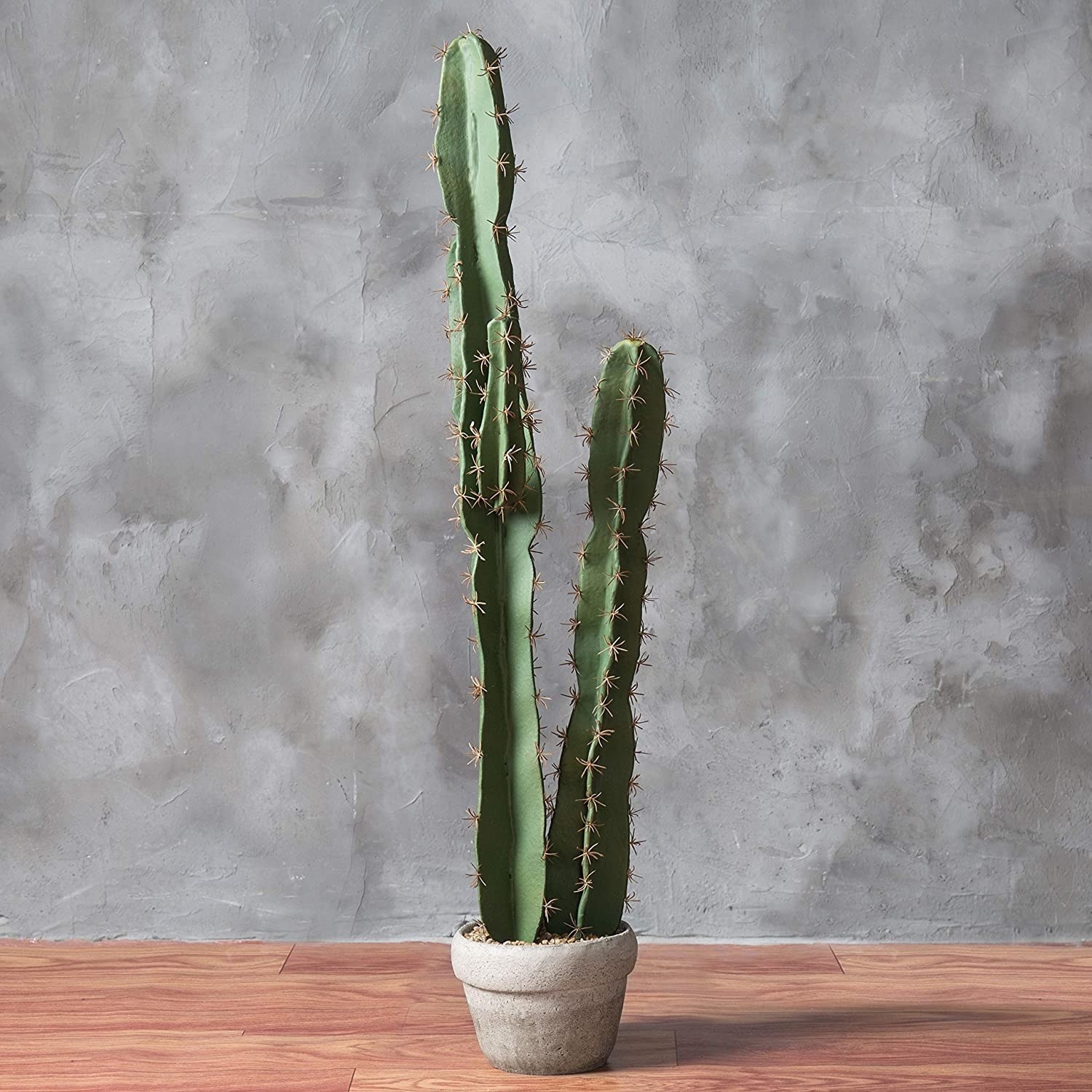 tall faux cactus in cement pot
