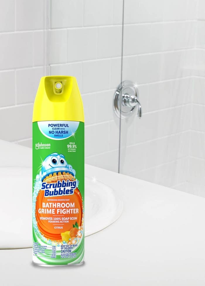the green and orange bottle in front of a shower