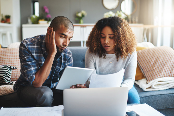 Couple looking stressed as they look at their bills