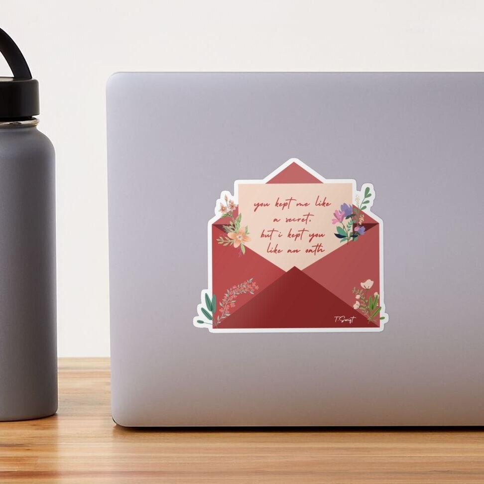 computer with medium size sticker shaped like a red envelope with taylor swift&#x27;s name open revealing a letter with the lyric on it