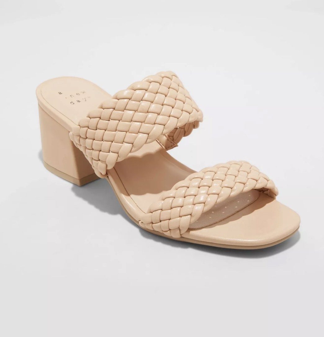 The tan sandals have a chunky heel and two braided straps
