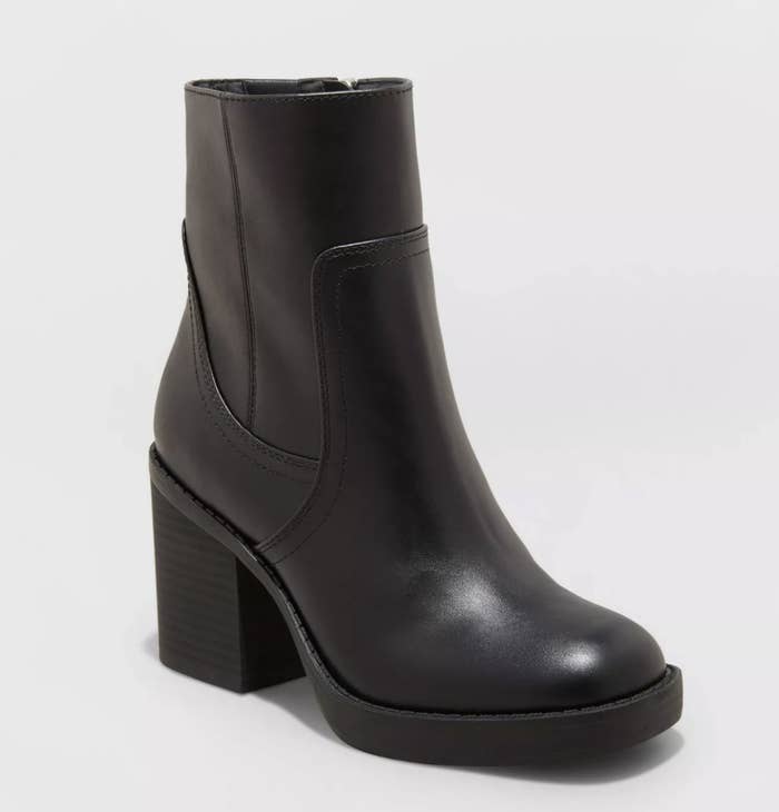 The black platform boots have intricate stitch detailing and a zip closure