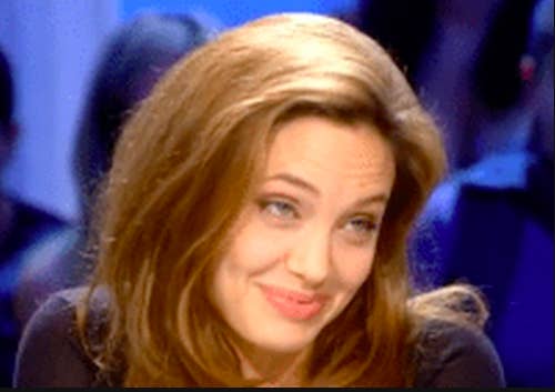 Angelina smirking while on a talk show