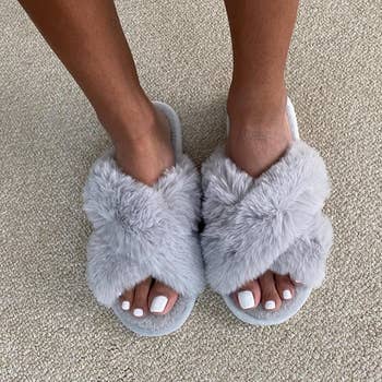 reviewer wearing the grey slippers