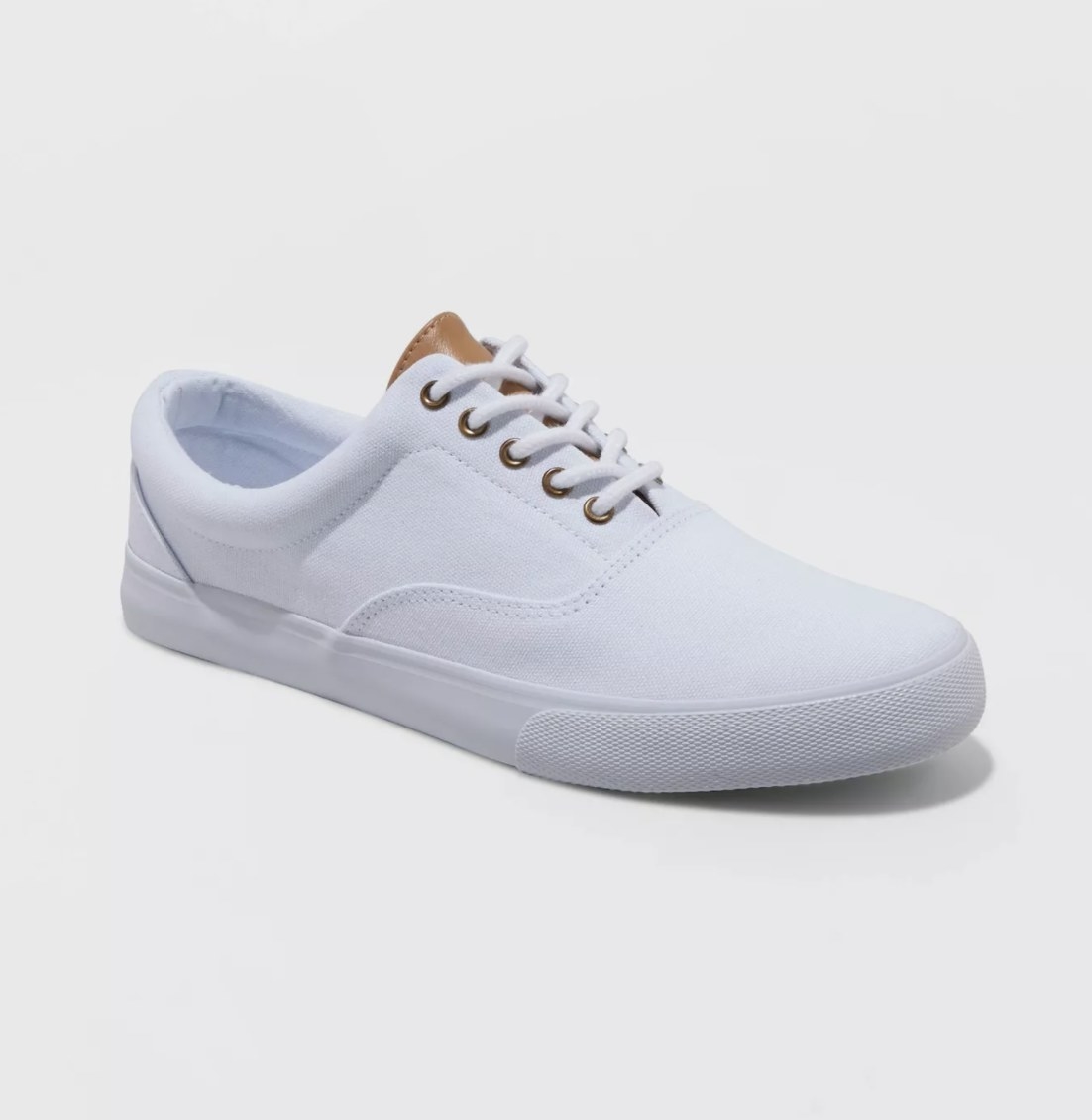 The white sneakers have a brown leather-like tongue and tonal laces