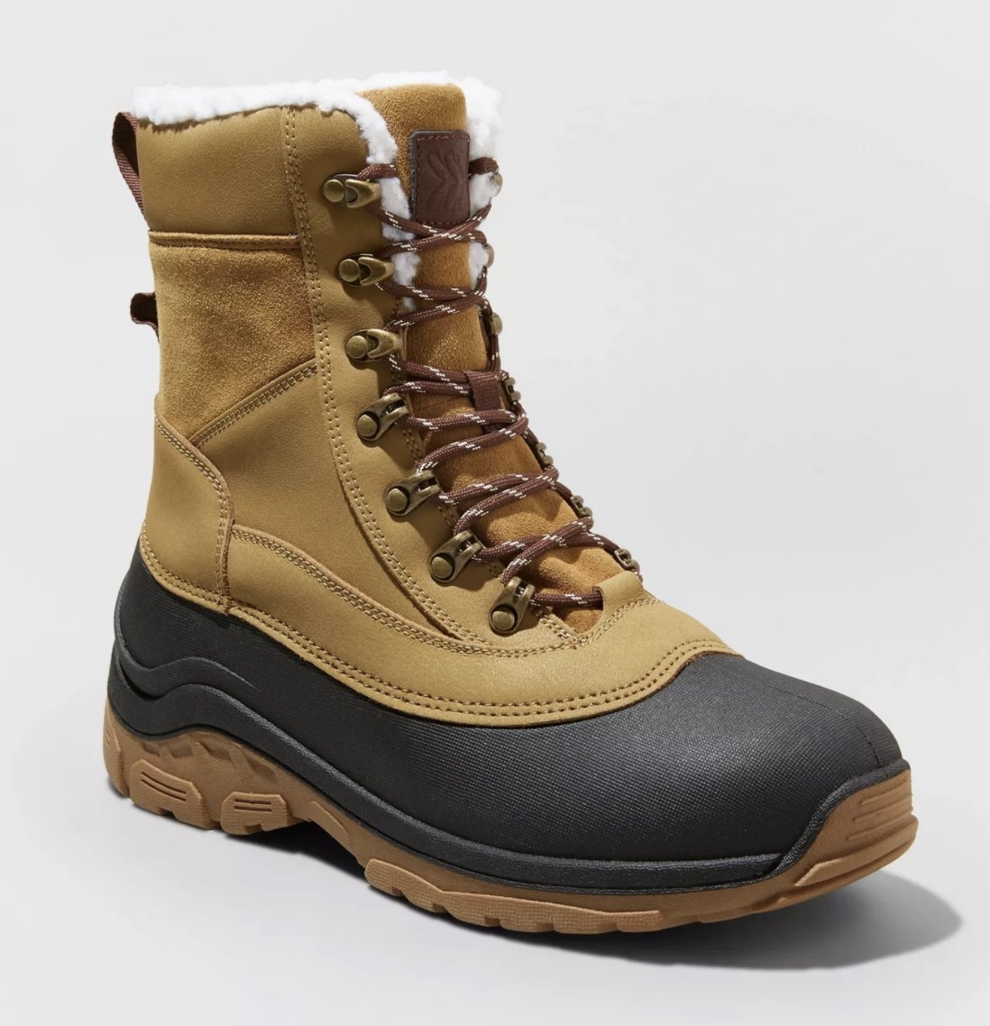 The tan and black hiking boots have a thick rubber black and tan sole