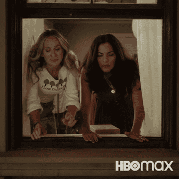 Carrie and Seema looking out a window in