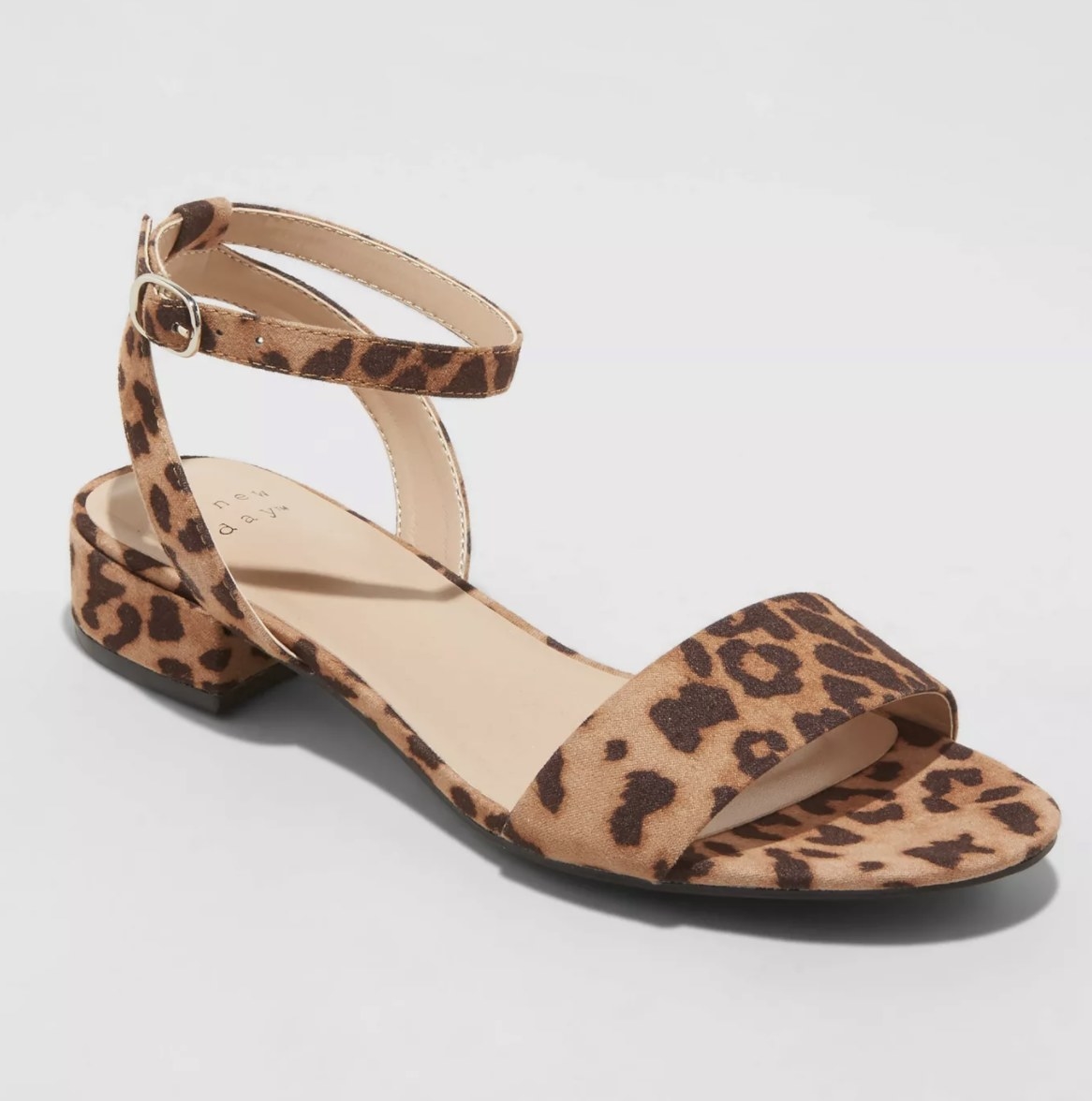The leopard patterned sandal has a slight heel and cute strappy additions around the ankle