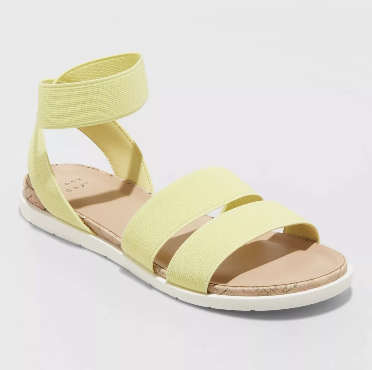 The bright yellow sandals have two toe straps and an ankle strap