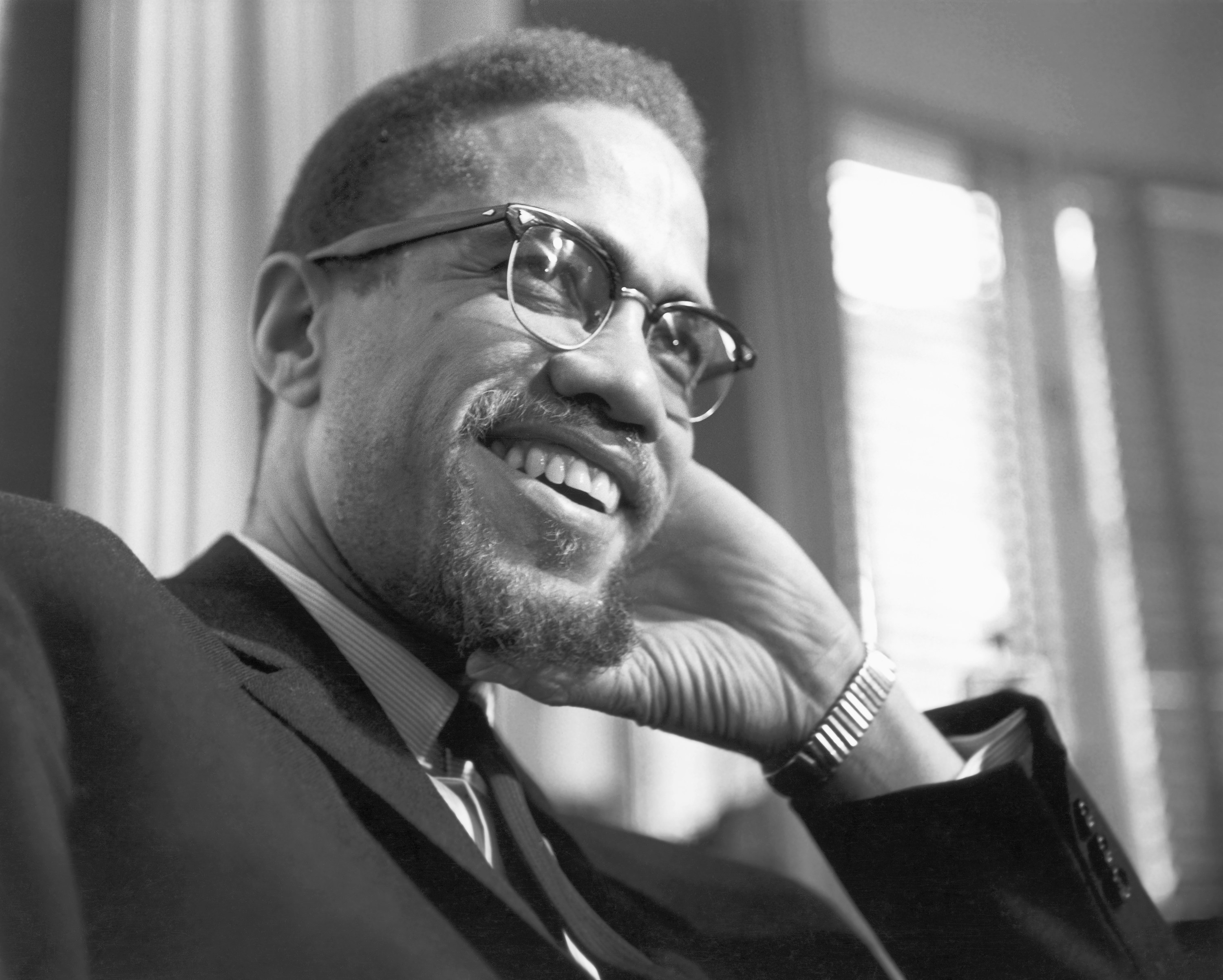 Malcolm X smiles a portrait in Rochester, New York on February 16, 1965