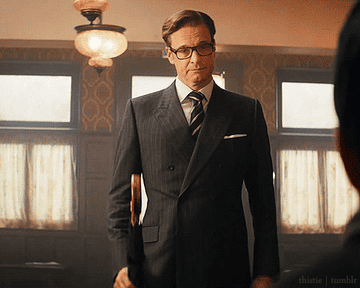 Colin Firth as Harry Hart in Kingsman throwing his umbrella from one hand to the other