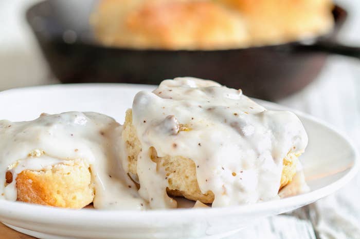 Biscuits from scratch covered with thick white sausage gravy.