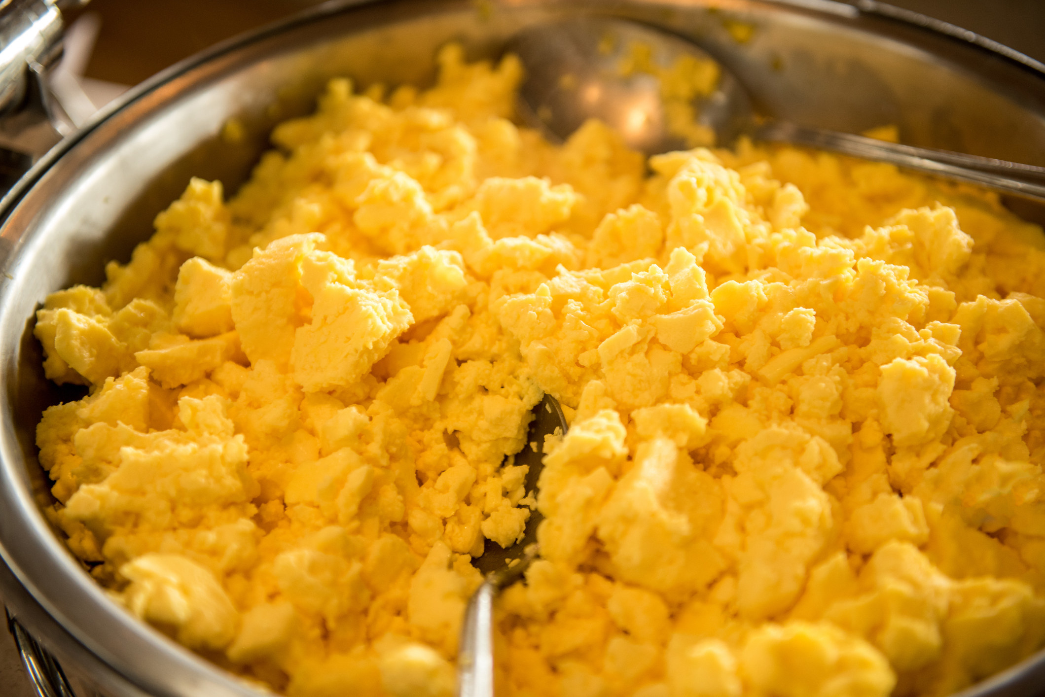 Close up of cooked, dry scrambled eggs.