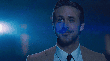 Ryan Gosling as Sebastian in La La Land smiling into the distance