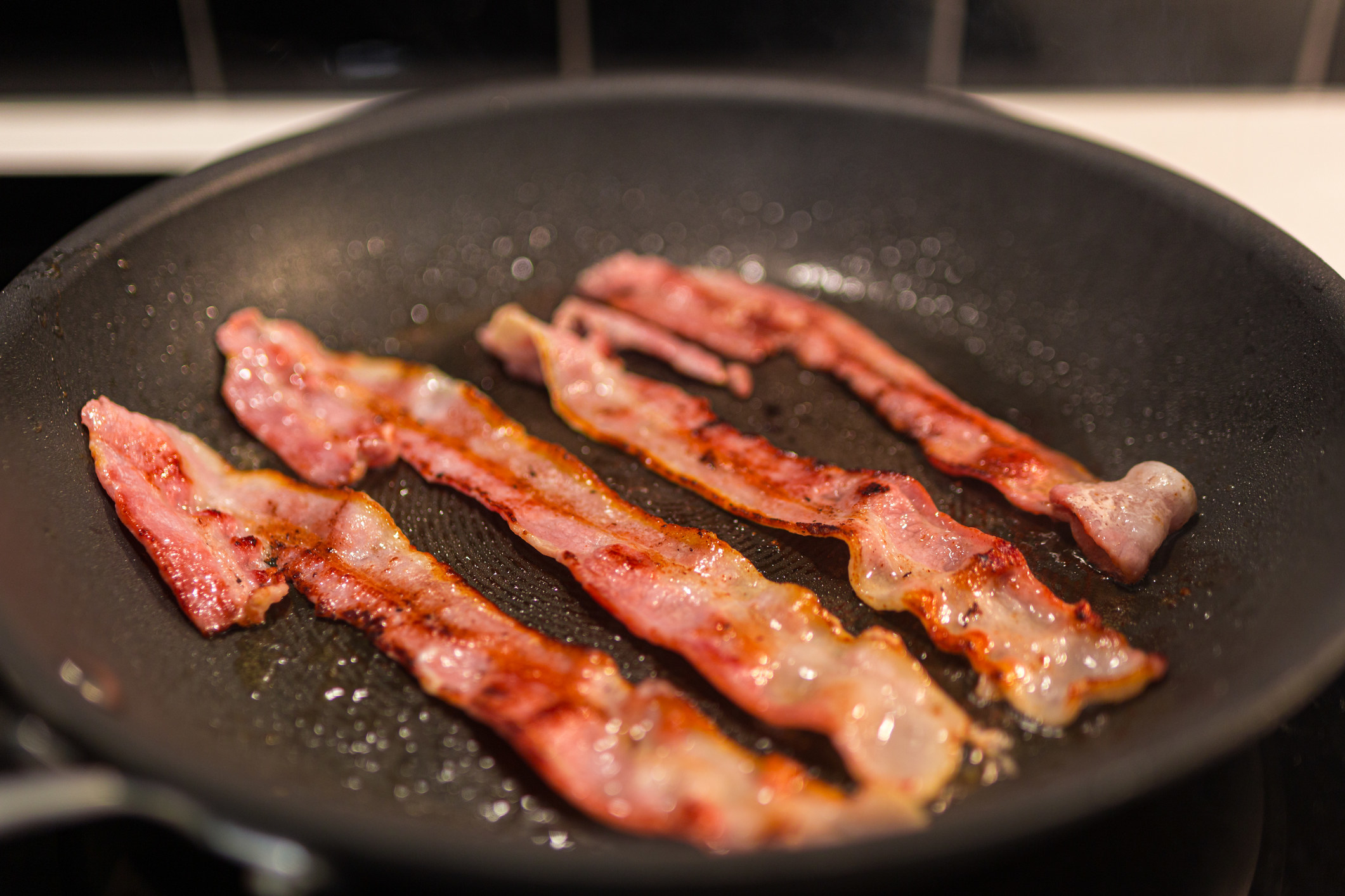 Bacon in a frying pan.