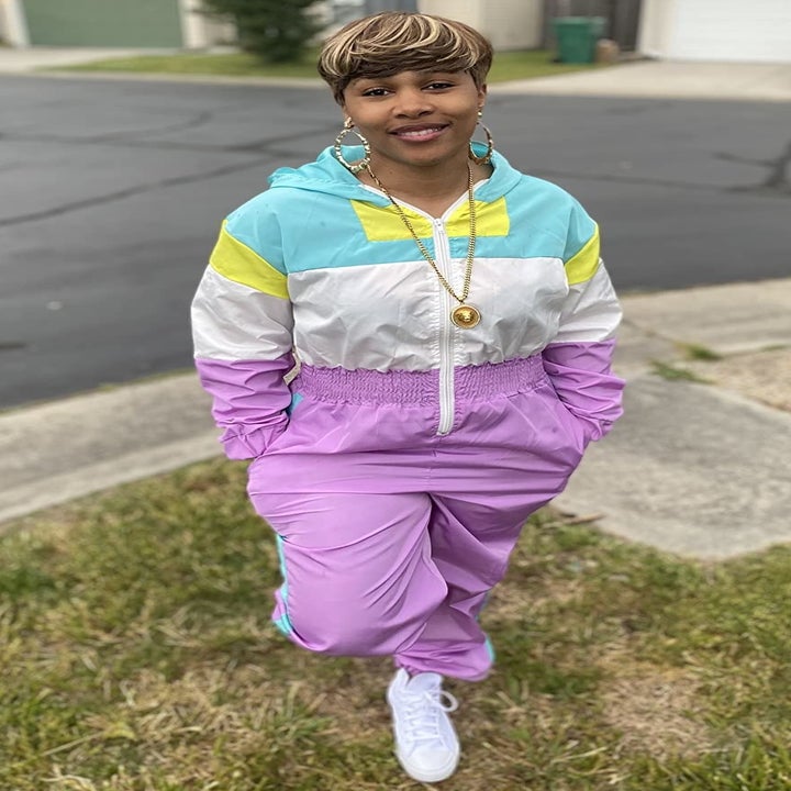 reviewer wearing the purple, blue, yellow, and white tracksuit