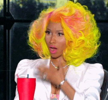 A taken aback Nicki Minaj covers her mouth in shock