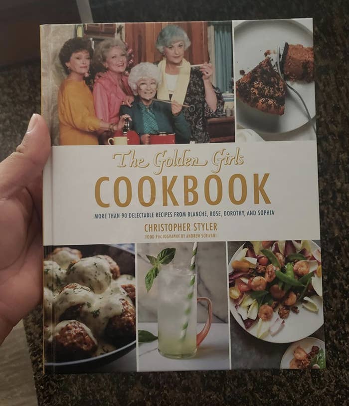 A reviewer holding the cookbook