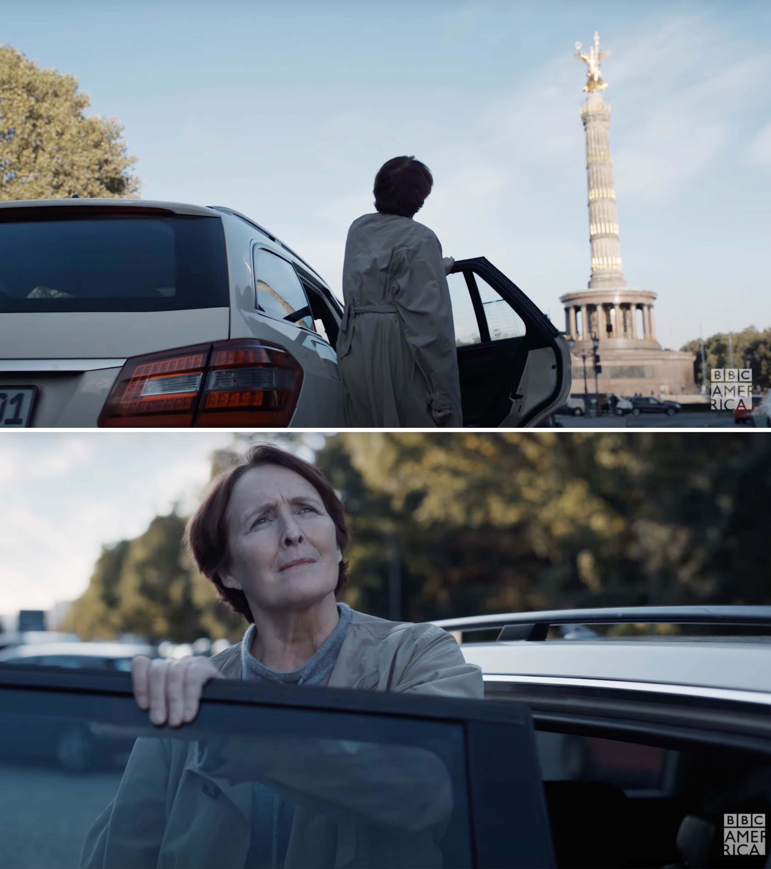 Carolyn looking at a landmark as she stands by a car