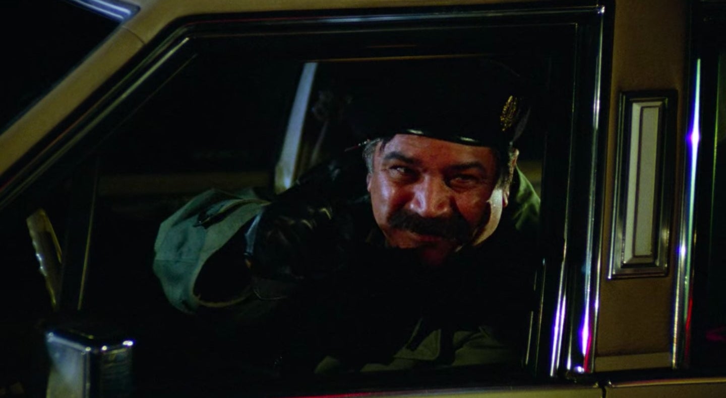 A man resembling Saddam Hussein in a car in "Seinfeld"