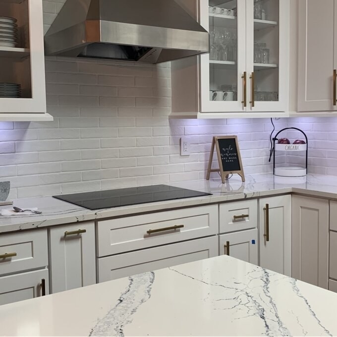 A reviewer&#x27;s image of tile used as a kitchen backsplash