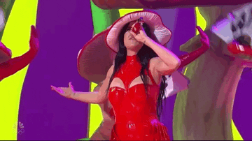 katy perry wearing red leather jumpsuit and mushroom hat