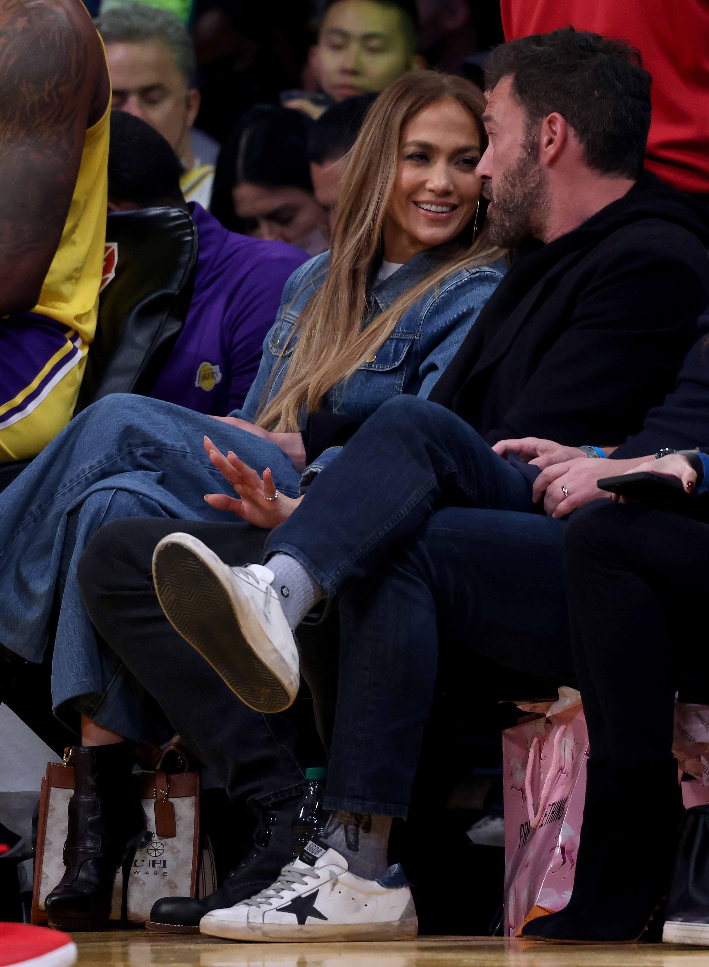 The couple sitting court side at a basketball game