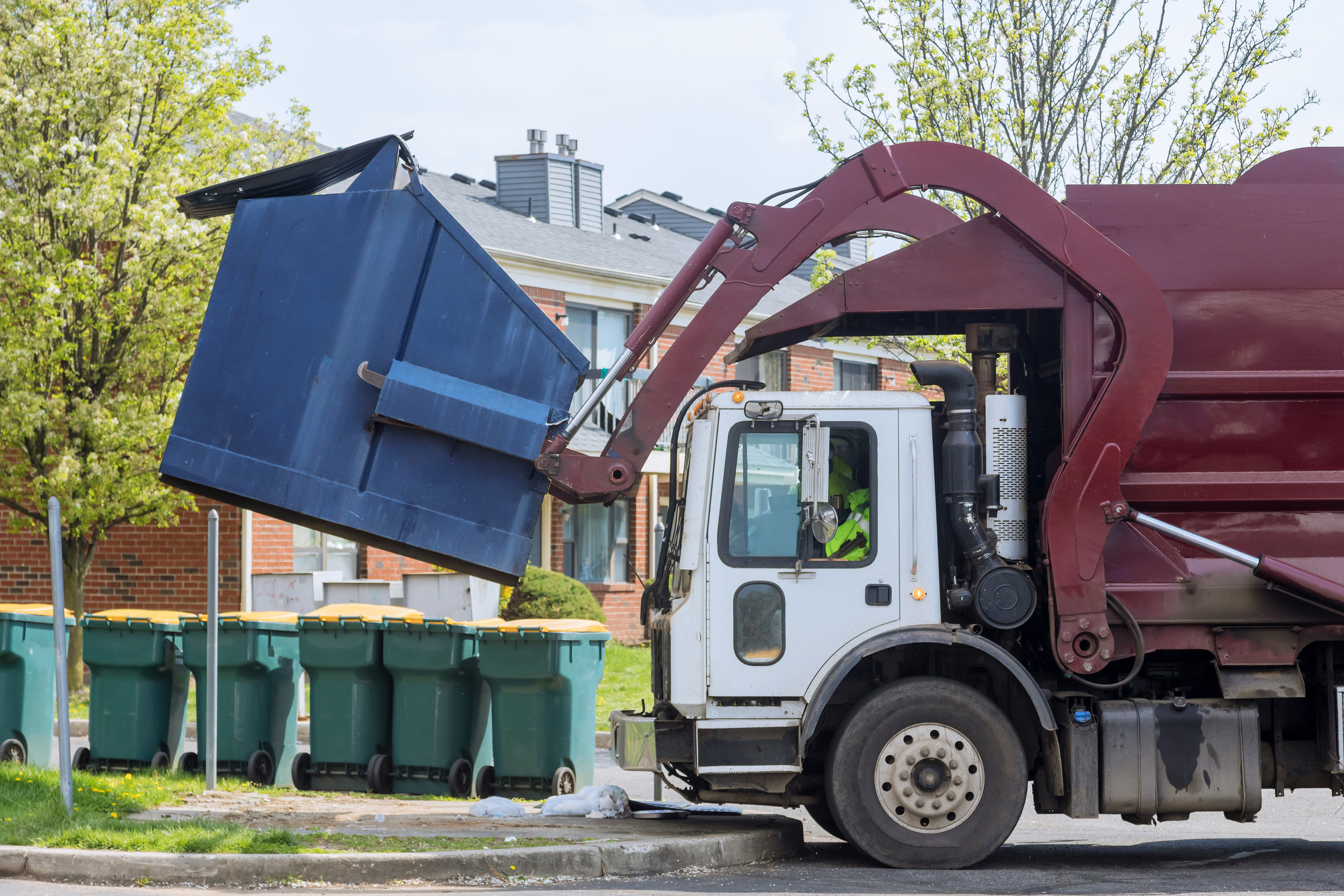 Trash truck emptying a dumpster