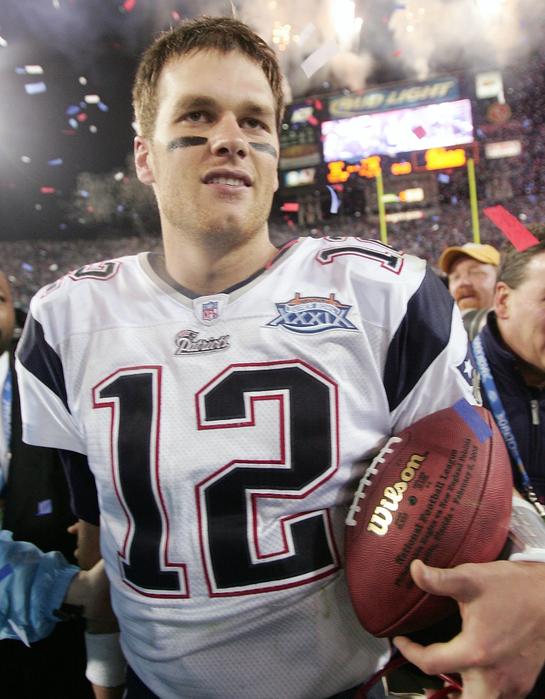 Tom Brady holds football