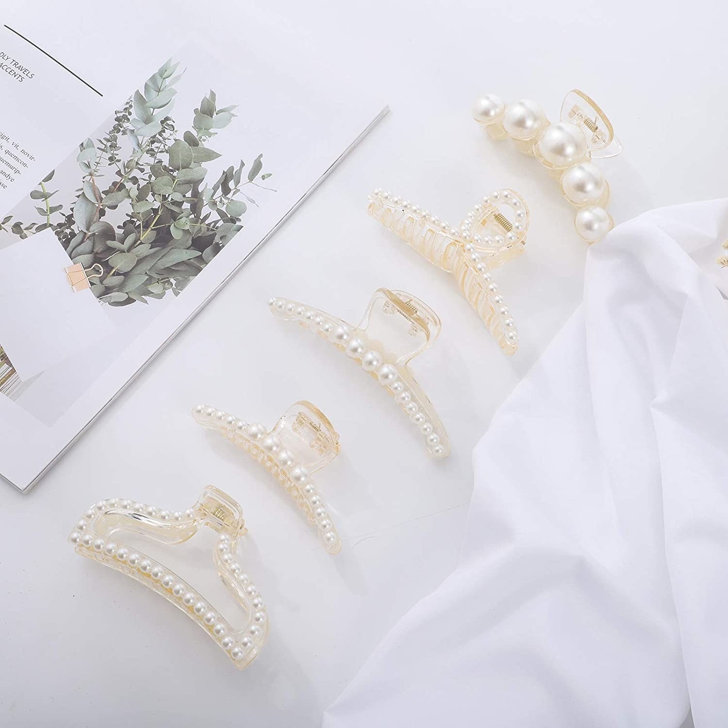 a flatlay of several faux pearl-encrusted hair clips
