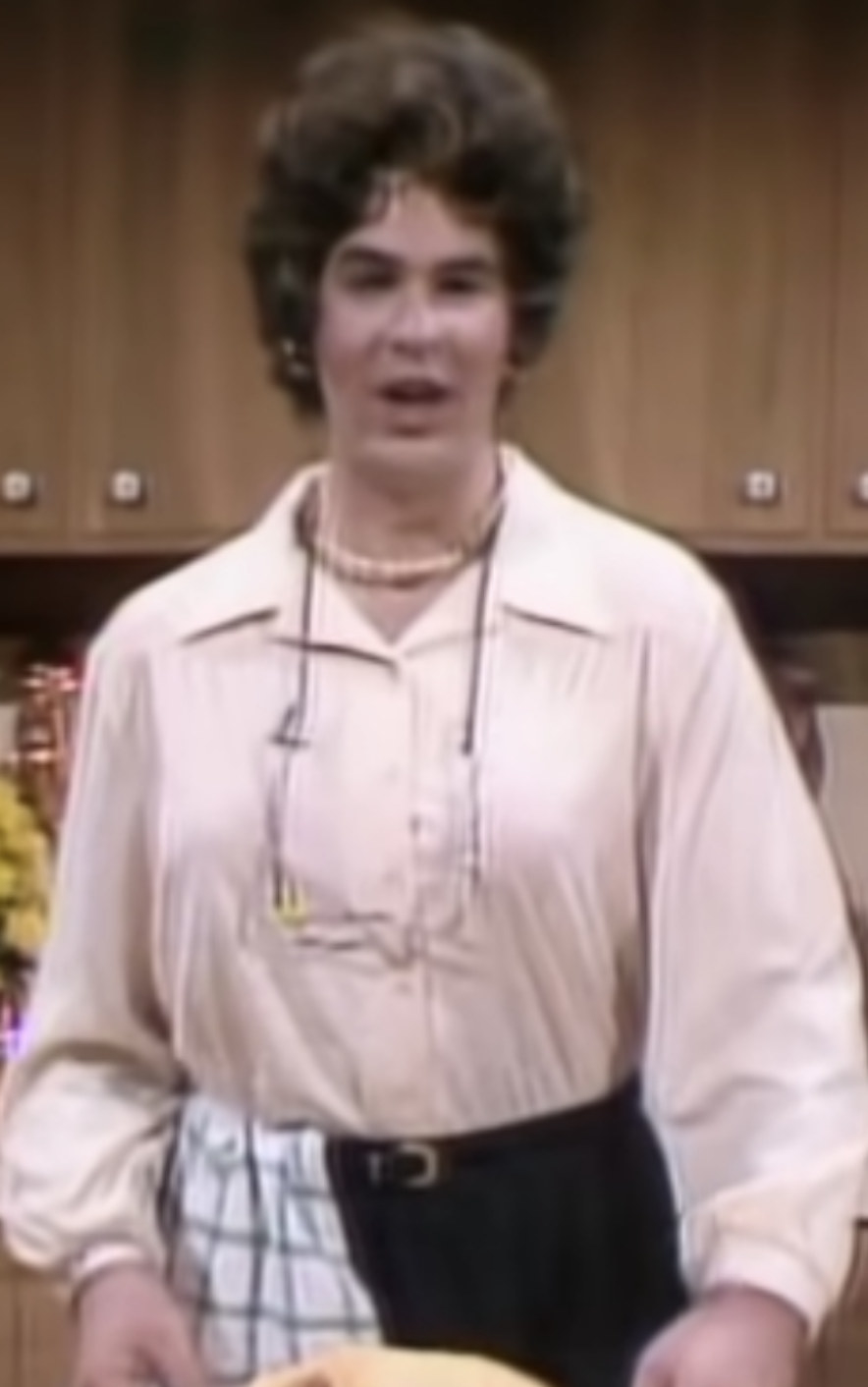 Aykroyd wearing a Julia Child-like hairdo and outfit