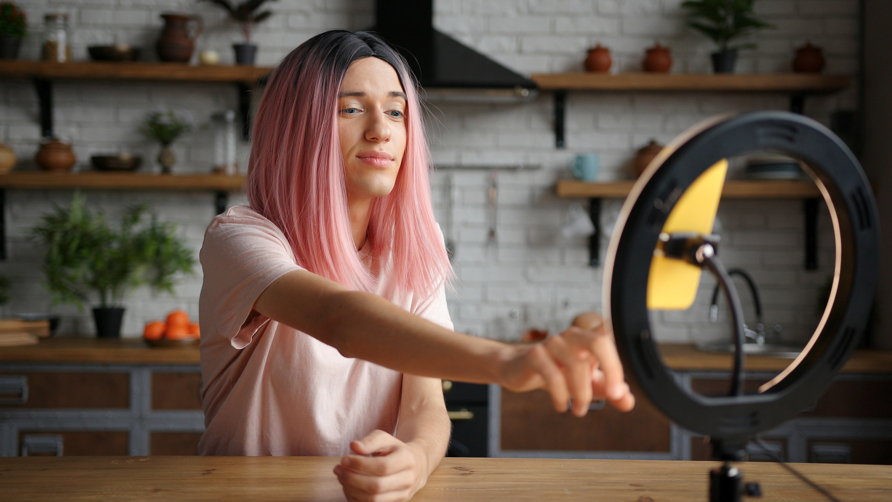 Woman using a ring light and a phone stand