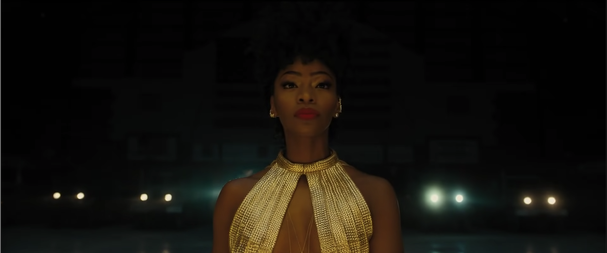 one of the stars of Chi-Raq in a golden gown