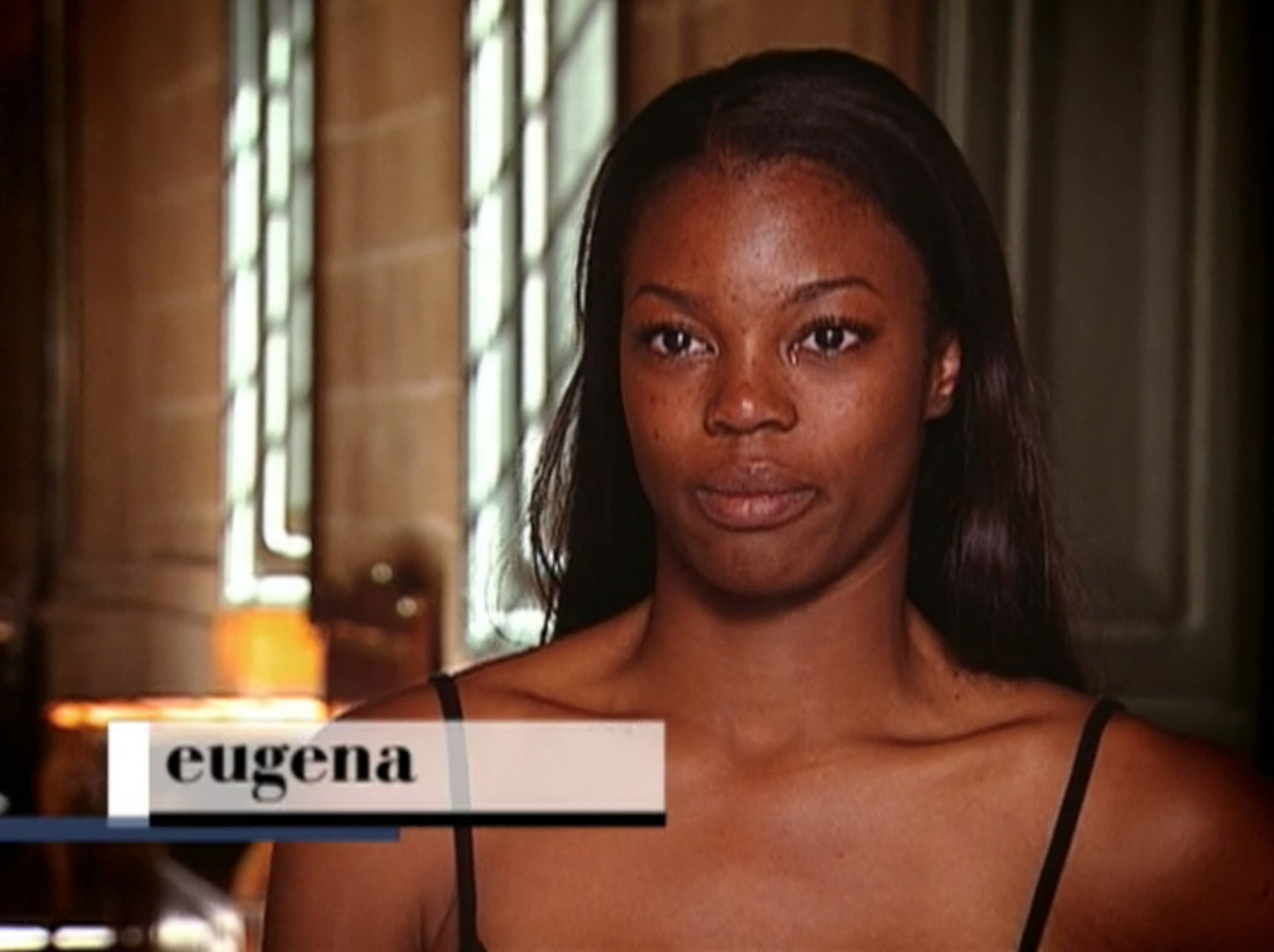 Eugena talking in a confessional