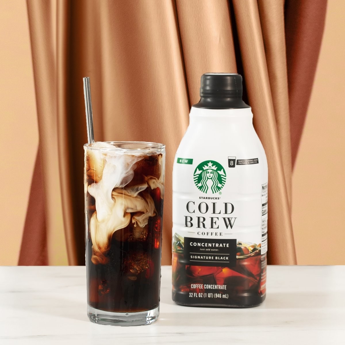 a bottle of the cold brew concentrate next to a glass filled with cold brew