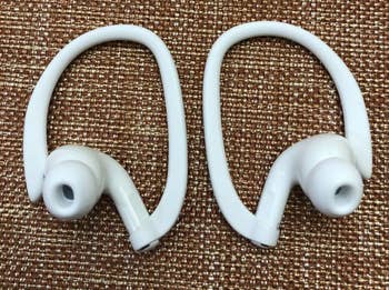 A customer review photo of the airpods with the ear hooks
