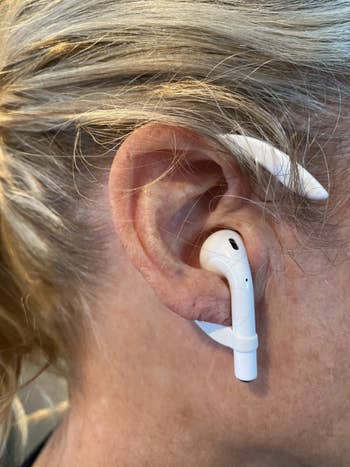 A customer review photo of them wearing their Airpod with the ear hooks