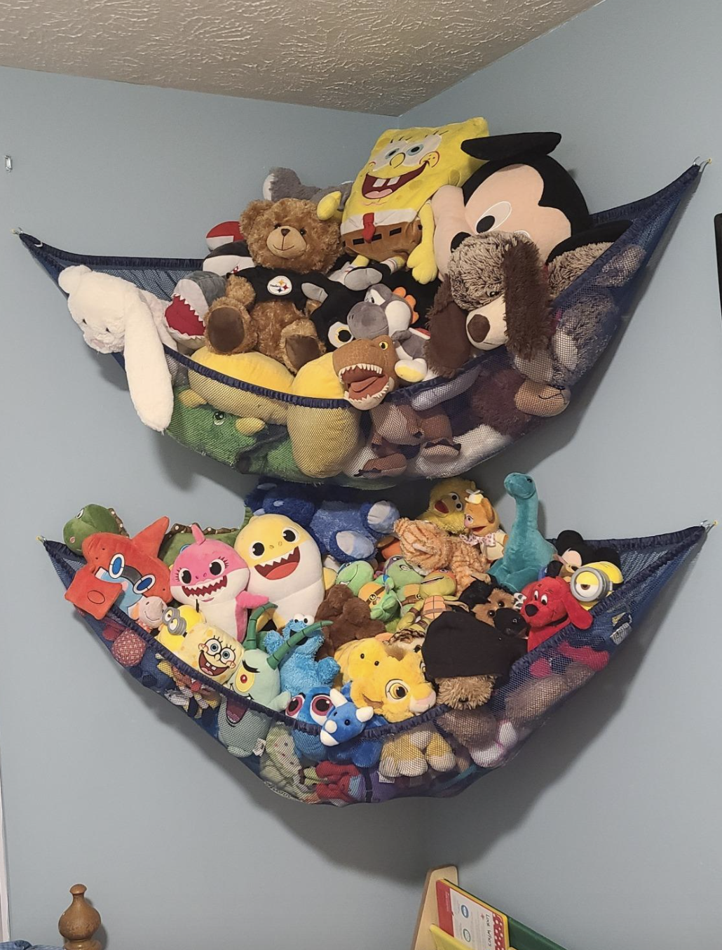 A customer review photo of the hammocks holding hundreds of stuffed animals