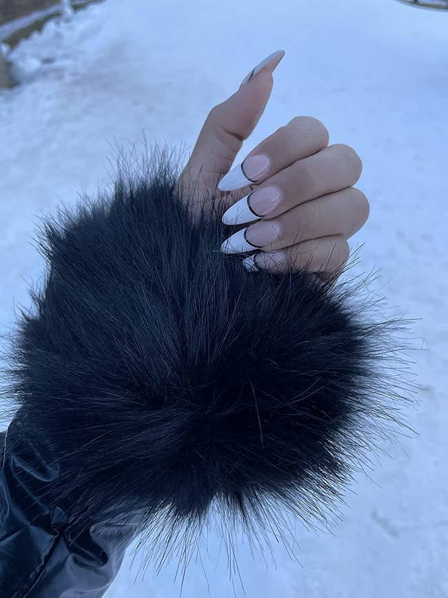reviewer with the black faux fur cuffs