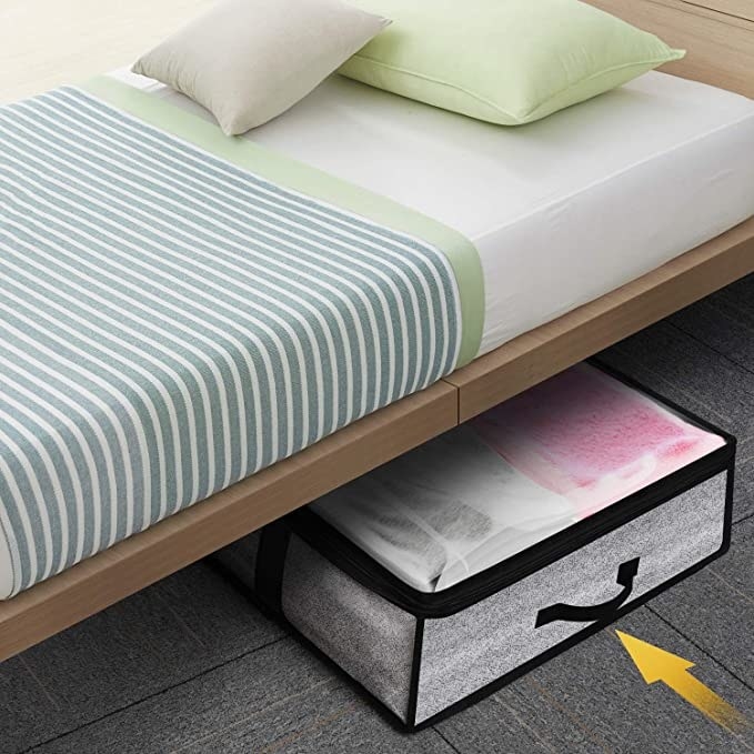 One of the storage boxes sliding under a bed