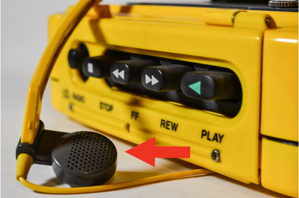 Close up of a yellow Walkman with headphones