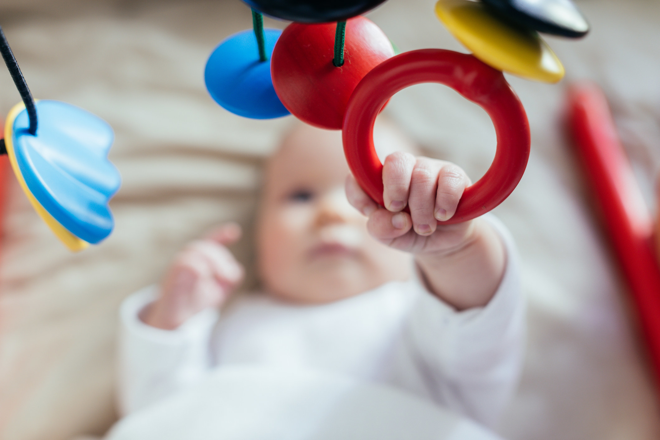 Baby reaching for toy