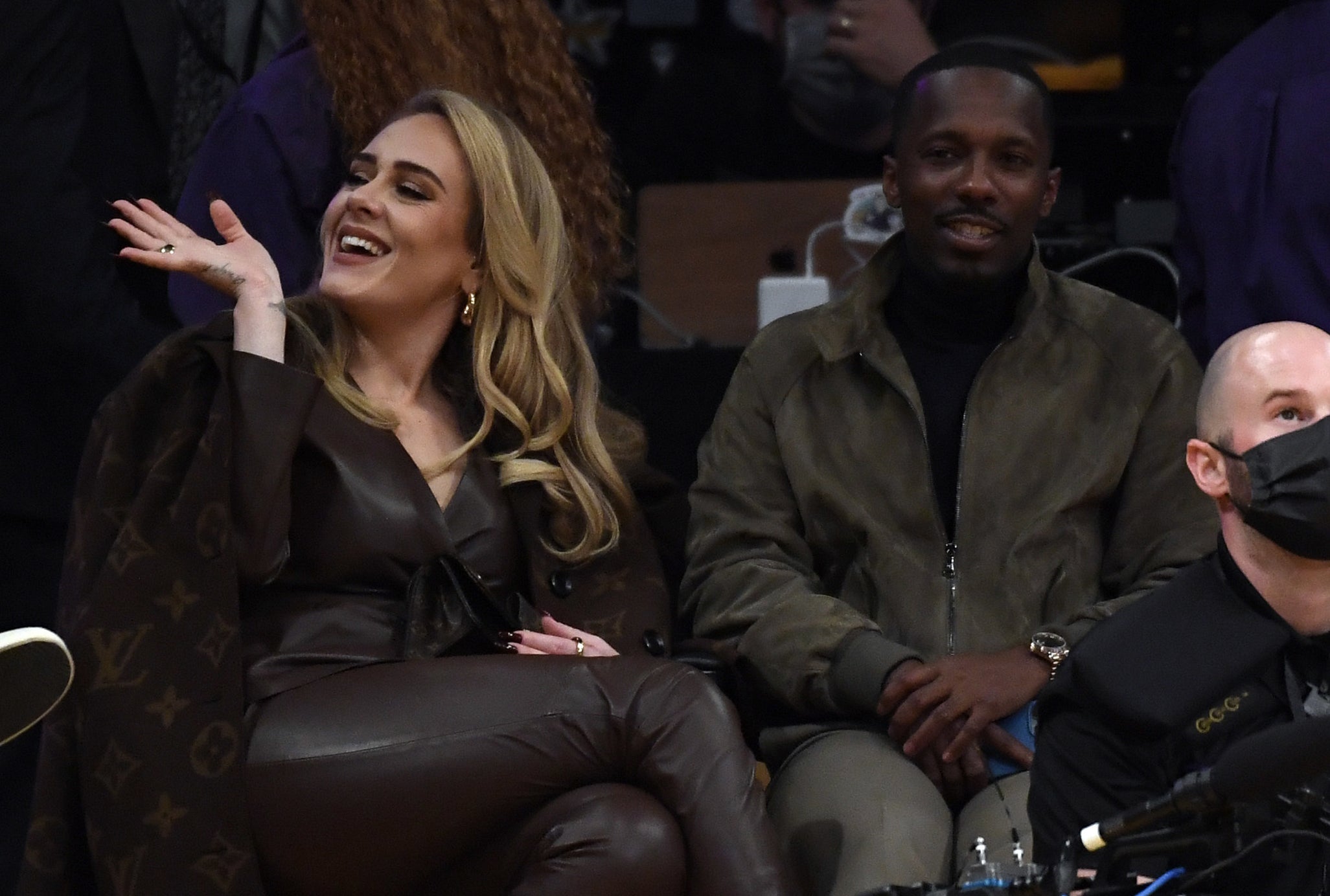 Adele and Rich sit court side at a basketball game