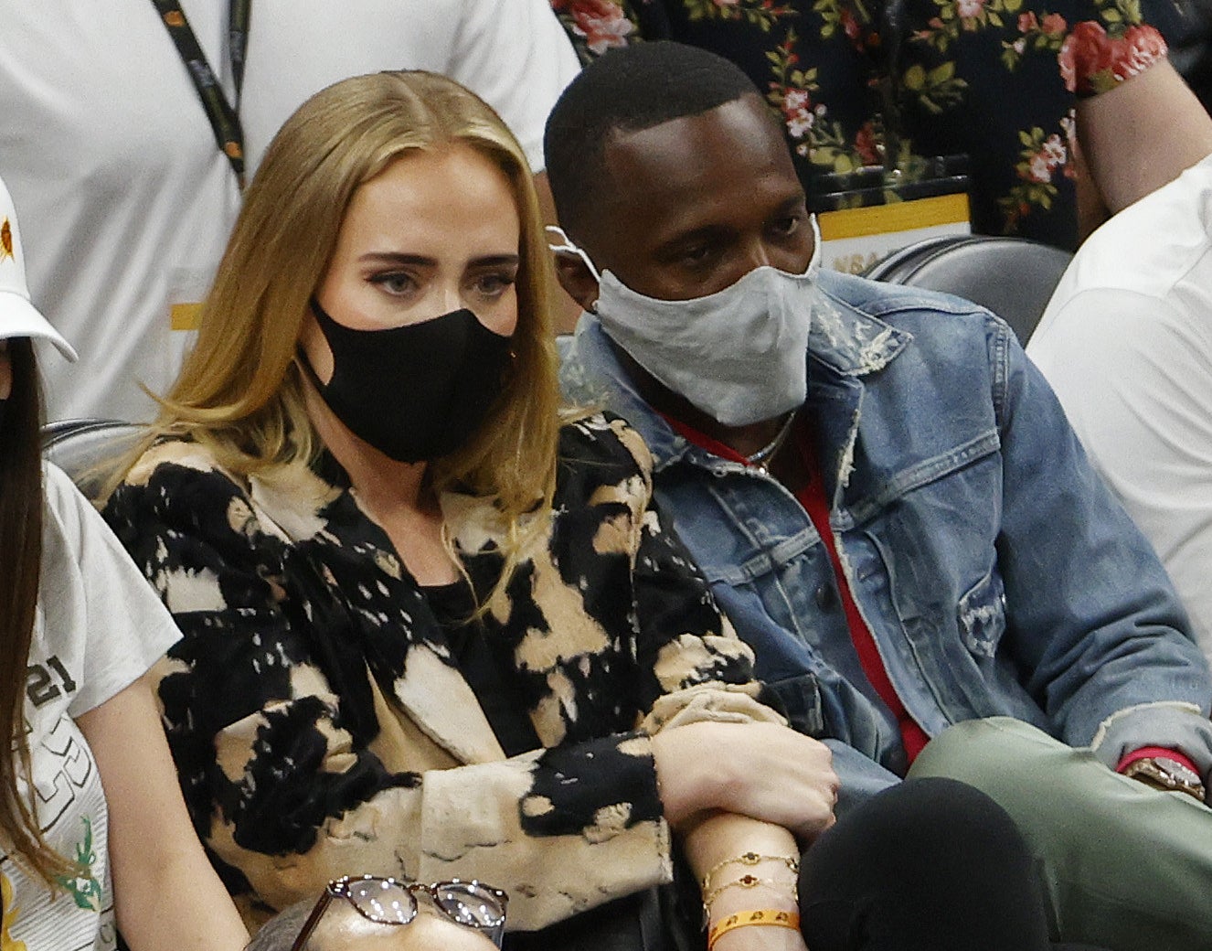 Adele and Rich sit court side at a basketball game