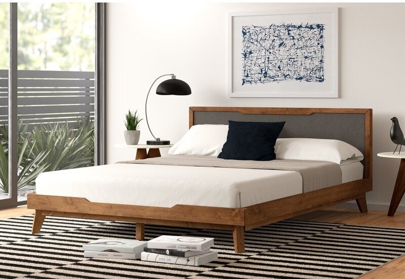 wood platform bed with wood and gray headboard